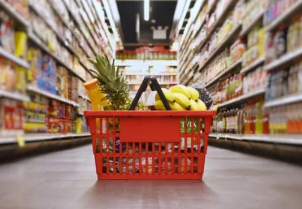 Grocery basket filled up sitting on the floor in the store