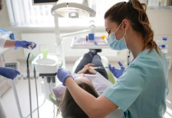 Dentist working on patient.