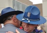 Former Jones County Deputy Bradley Boyd (in former MHP uniform) hugs his father.