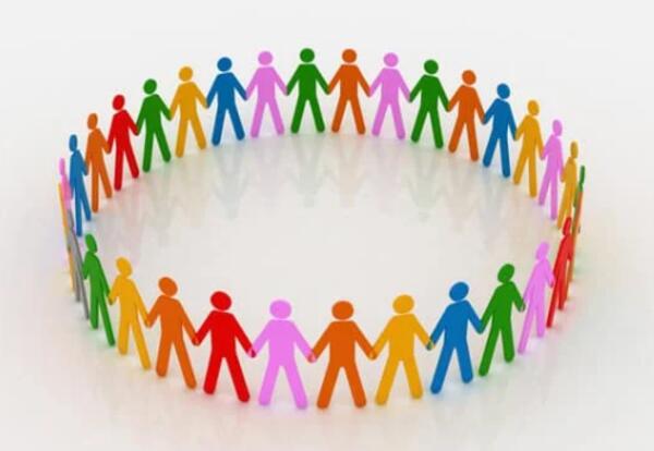 Colorful paper people cutouts holding hands in a circle